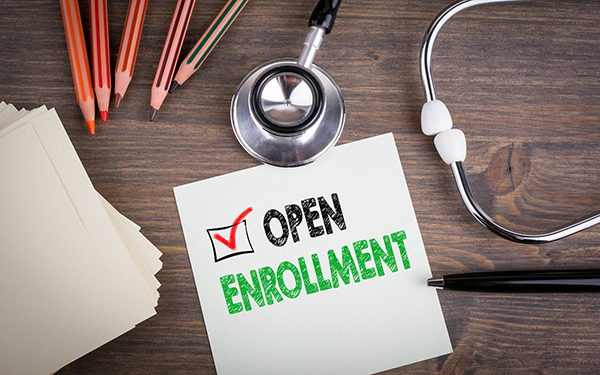 Open Enrollment. Workplace of a doctor. Stethoscope on wooden desk