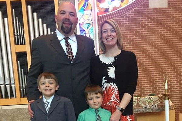 Photo of Michael Downs with his wife and two sons